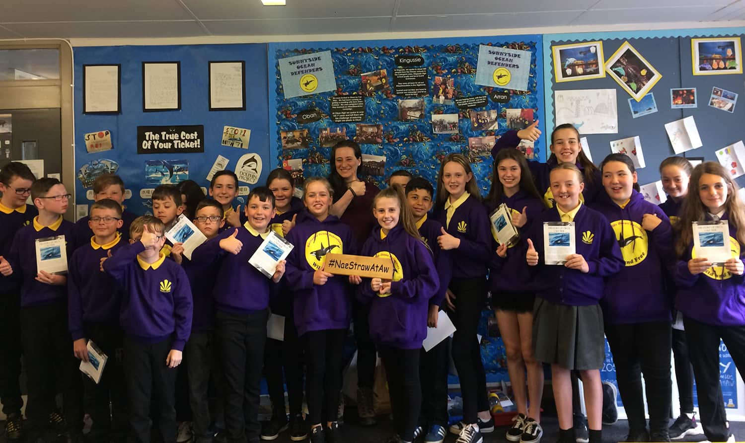 The Sunnyside Ocean Defenders with their "Tide" storybooks and Marie in their classroom